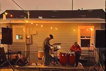 people playing drums on the front porch